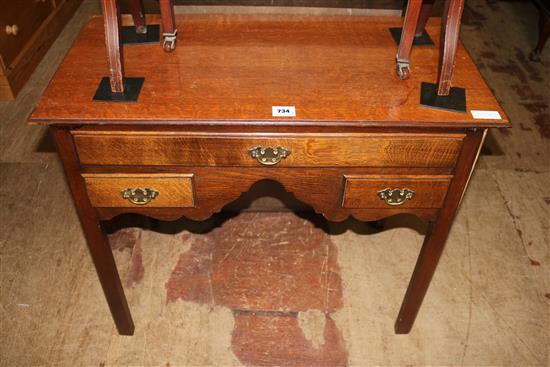 A late Georgian oak three drawer lowboy